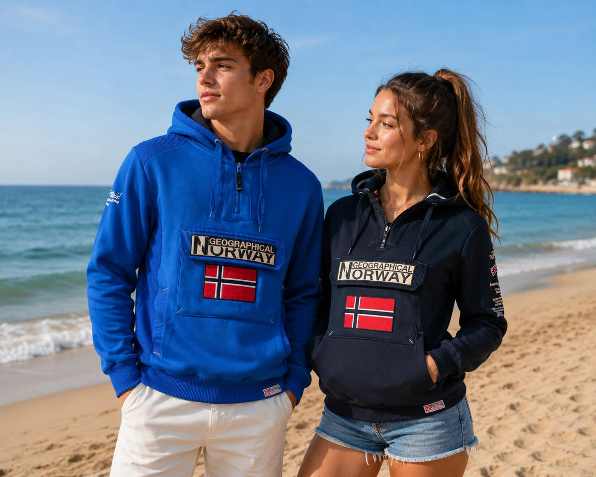 Dos modelos con sudaderas Geographical Norway junto al mar